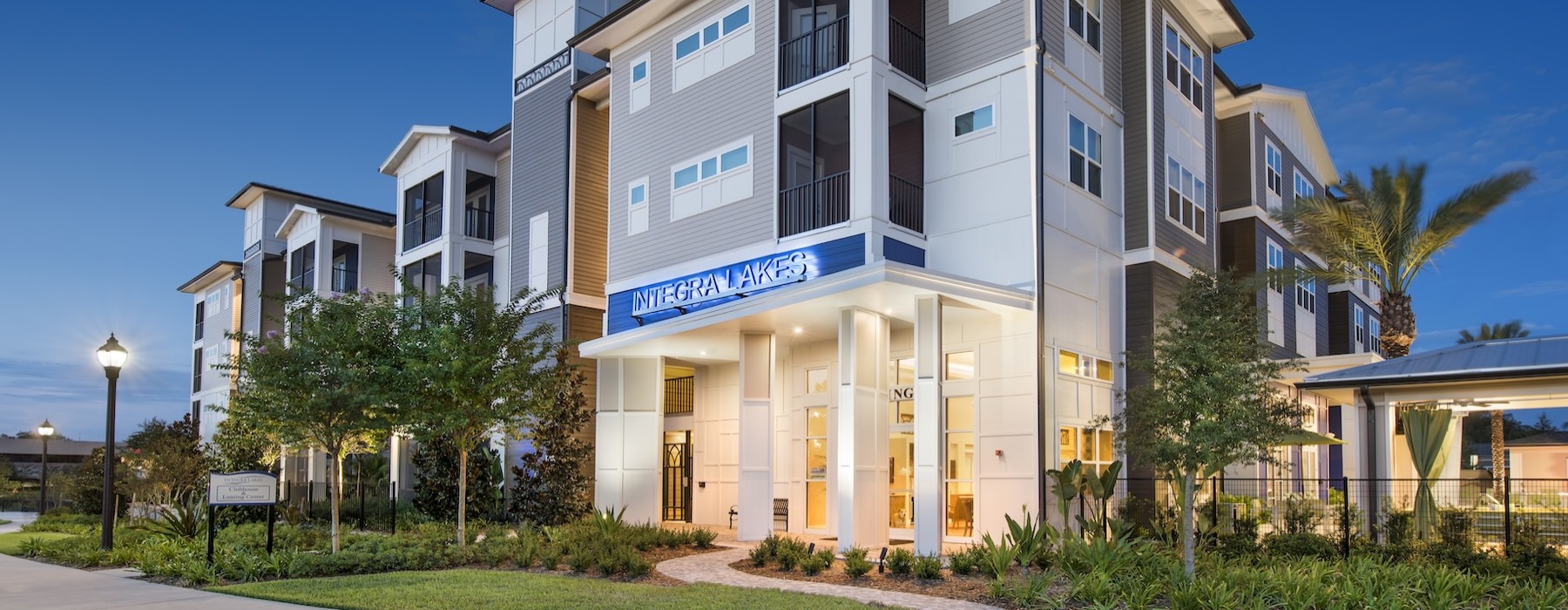 a building with trees and grass