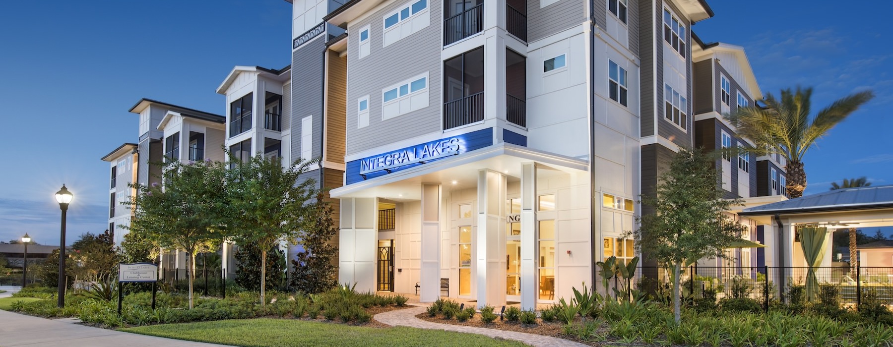 a building with trees and grass