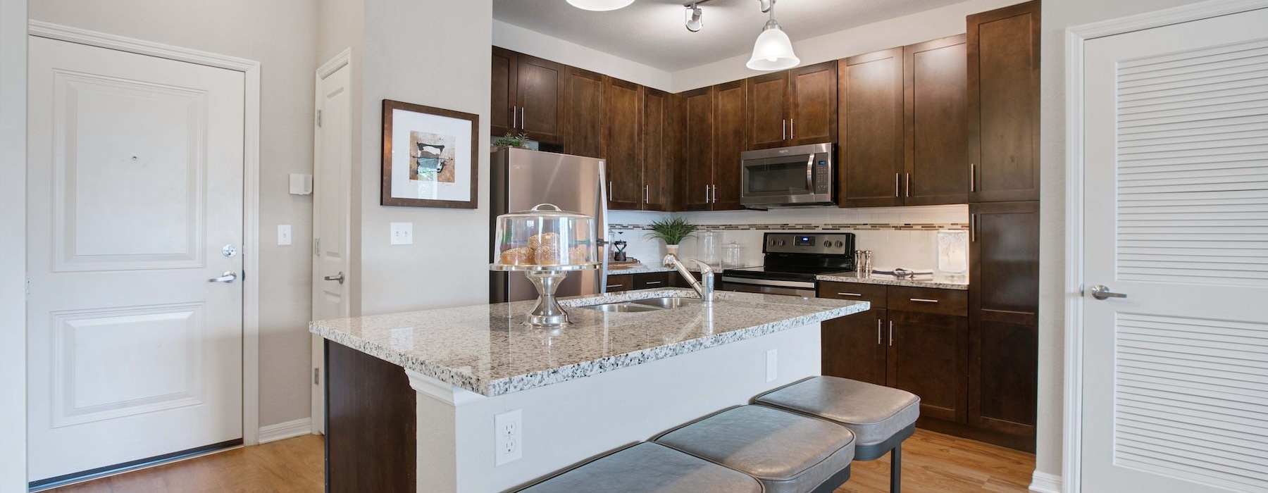 a kitchen with a marble island