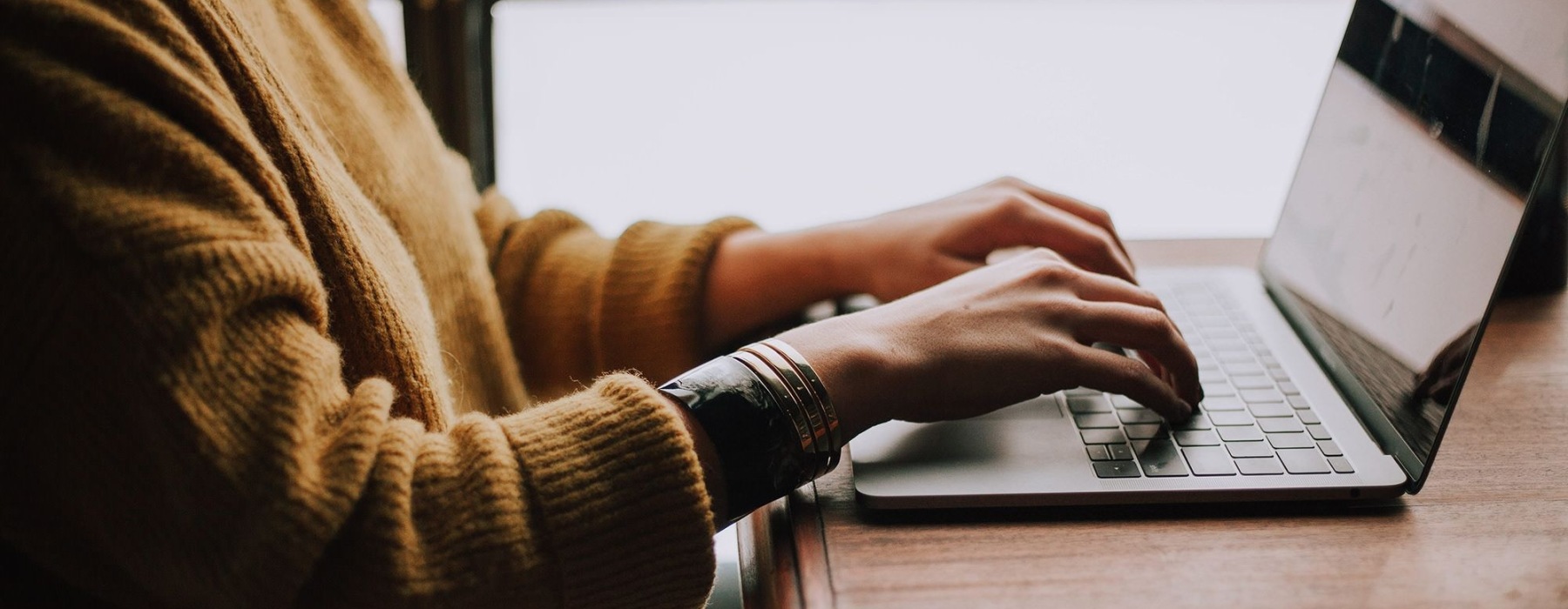 a woman typing at a computer